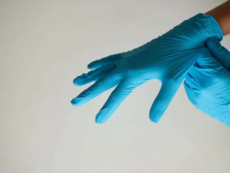 Close-up of a disposable glove and cuff; illustrative material detail, not a verified LANSI product.